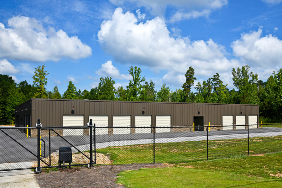 Picture of a chain link fence in front of a commercial building.